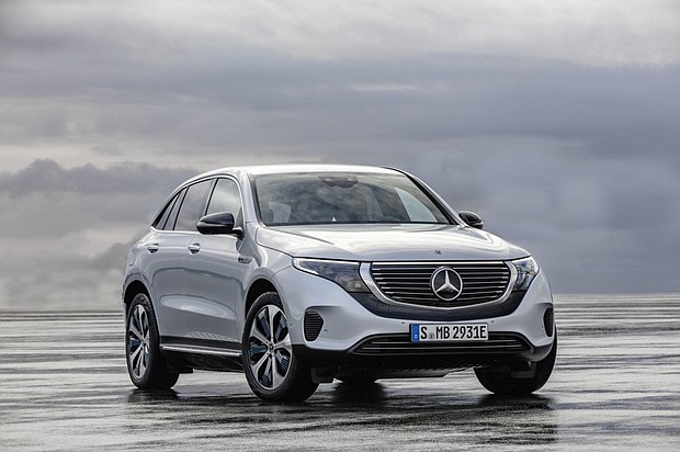 The Mercedes-Benz EQC is differentiated by a black band running under the grill and a bar of white light above it.