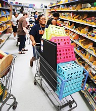 Huguenot High School teacher Catrina Cheeks happily fills her shopping cart with school supplies Wednesday at a Walmart store in South Side. She was among an estimated 200 teachers from Huguenot, Elkhardt-Thompson Middle and Westover Hills Elementary schools surprised with a $200 shopping spree at the Sheila Lane store.  