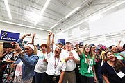 Huguenot High School Principal Robert “Rob” Gilstrap, center, joins in the celebration after teachers from the school learn they each have been awarded a $200 shopping spree. Location: The Walmart store on Sheila Lane, just a short distance from the school at 7945 Forest Hill Ave.   