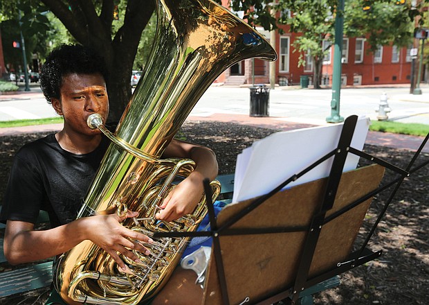 Practice, practice, practice
Terence Burks, 18, of Williamsburg practices his tuba at the corner of Harrison Street and Park Avenue outside the Music Department at Virginia Commonwealth University in The Fan. The second year music education major was getting ready for an audition. Practice makes perfect. (Regina H. Boone/Richmond Free Press)
