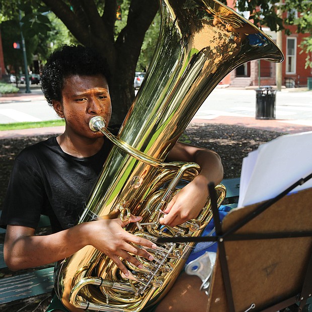 Practice, practice, practice
Terence Burks, 18, of Williamsburg practices his tuba at the corner of Harrison Street and Park Avenue outside the Music Department at Virginia Commonwealth University in The Fan. The second year music education major was getting ready for an audition. Practice makes perfect. (Regina H. Boone/Richmond Free Press)