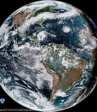 An enhanced satellite image showing Hurricane Florence, third from right, west of Isaac and Helene.