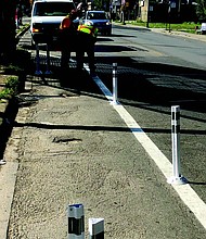 The Garfield Park Community Council, along with Chicago’s Vision Zero campaign, recently hosted their final Light in the Night event of the summer near the Kedzie Green Line station where plastic stanchions were recently installed to slow down traffic and protect pedestrians. Photo Credit: Provided by the Garfield Park Community Council
