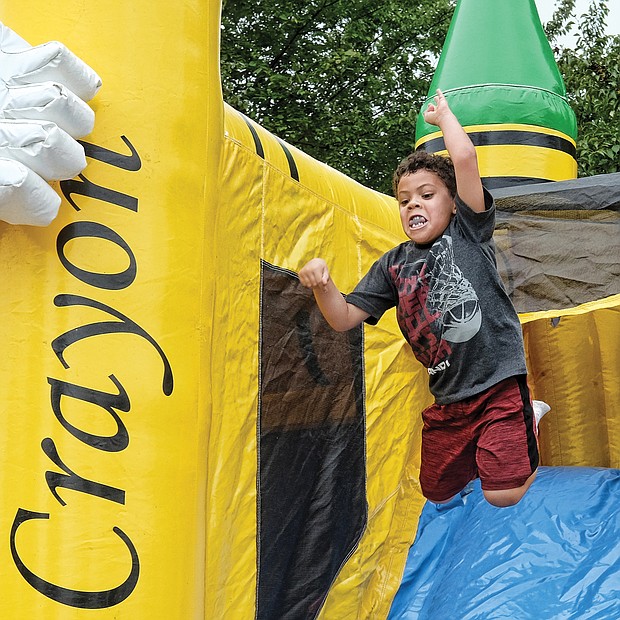 Isaac Williams, 5, goes into high-flying motion on the Big Bomb Bounce last Saturday at the Church Hill Reunion at Ethel Bailey Furman Park on North 28th Street. This was the 35th year for the annual event celebrating fellowship and community uplift. (Sandra Sellars/Richmond Free Press)