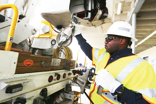 Dominion Energy’s Dennis McDade of Fairfax packs his truck Wednesday morning as he prepares for the job ahead of restoring electric power to homes and businesses in the wake of Hurricane Florence. Mr. McDade said this is the 13th or 14th hurricane he has worked through.