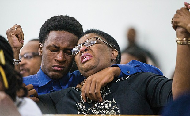 Allison Jean leans on her son, Brandt, during a prayer service last Sunday at Dallas West Church of Christ for her 26-year-old son, Botham Jean, above, who was shot and killed in his apartment Sept. 6 by Dallas Police Officer Amber Guyger.