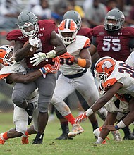 Tabyus Taylor pushes through the Carson-Newman University defense to carry the ball in last Saturday’s game at Hovey Field. Despite VUU’s loss, Taylor ran for 109 yards and two touchdowns.
