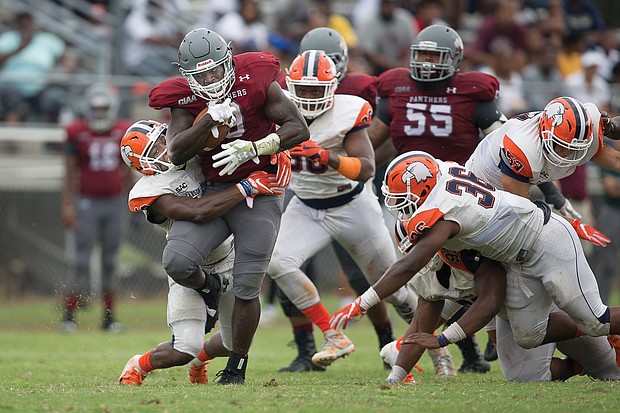 Tabyus Taylor pushes through the Carson-Newman University defense to carry the ball in last Saturday’s game at Hovey Field. Despite VUU’s loss, Taylor ran for 109 yards and two touchdowns.