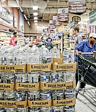 Shoppers at Farm Fresh supermarket on East Main Street in Richmond’s Shockoe Bottom fill up on bottled water and supplies Tuesday as Hurricane Florence threatens Virginia and at least three other states.