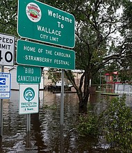 Floodwaters rose overnight in the town of Wallace, North Carolina, some 40 miles north of Wilmington. Overflowing creeks and rivers in southeastern North Carolina have made travel difficult in a region without power since Hurricane Florence made landfall Friday.