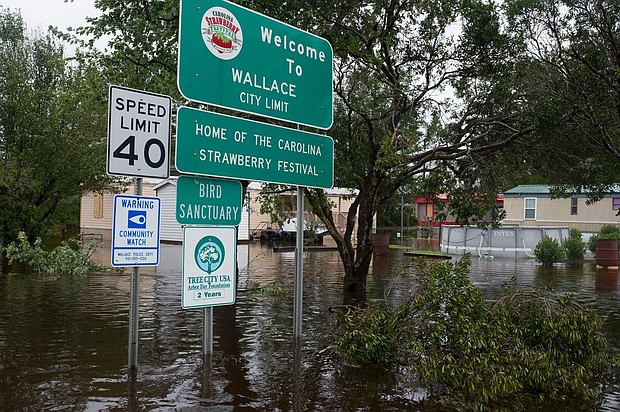 Floodwaters rose overnight in the town of Wallace, North Carolina, some 40 miles north of Wilmington. Overflowing creeks and rivers in southeastern North Carolina have made travel difficult in a region without power since Hurricane Florence made landfall Friday.