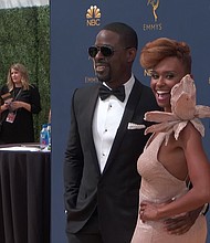Sterling K. Brown and his wife, Ryan Michelle Bathe, appear on the red carpet for the 70th Primetime Emmy Awards.
