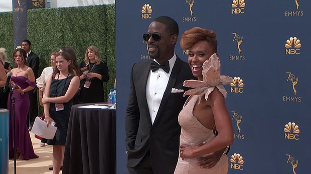 Sterling K. Brown and his wife, Ryan Michelle Bathe, appear on the red carpet for the 70th Primetime Emmy Awards.