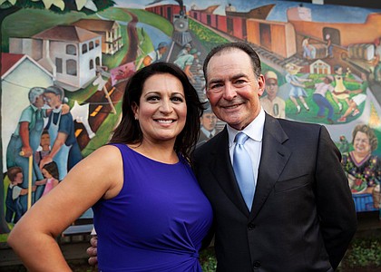 Christina Morales and Orlando Sanchez in front of the Mexican-American History & Culture in 20th Century Houston mural