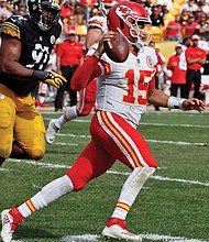 Kansas City Chiefs quarterback Patrick Mahomes scrambles away from Pittsburgh Steelers defensive end Stephon Tuitt during the second half of last Sunday’s game in Pittsburgh. The Chiefs won the game 42-37.