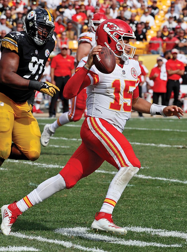 Kansas City Chiefs quarterback Patrick Mahomes scrambles away from Pittsburgh Steelers defensive end Stephon Tuitt during the second half of last Sunday’s game in Pittsburgh. The Chiefs won the game 42-37.