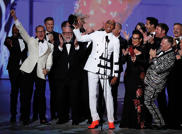 RuPaul Charles, originator of “RuPaul’s Drag Race,” is cheered by a bevy of supporters while accepting the Emmy for outstanding reality-competition program.