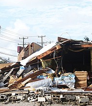 A crew works to restore power to businesses located near a store in Chesterfield County that was wrecked Monday when a tornado struck. The furniture store on Hull Street Road and Speeks Drive partially collapsed in the storm.