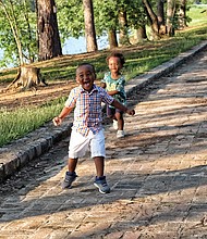Two-year-old cousins Khamryn Tyler, left, and Xavier Taylor enjoy the sunshine and running along a brick walkway at Shields Lake in Byrd Park on Wednesday during an outing with their moms, Benneka Tucker and Leesa Taylor, and their grandfather, Emanuel Crawford. Area residents welcomed the nice weather after the string of overcast days and sheets of rain associated with the hurricane.
