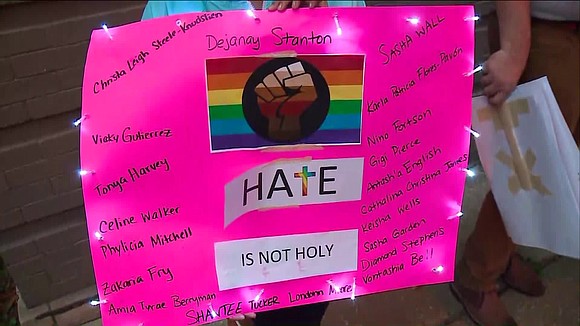 A protest was held after a priest on the city's North Side burned an LGBTQ flag outside his Avondale church …