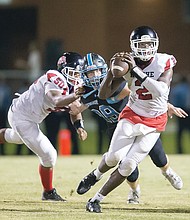 George Wythe High School quarterback Emontre Bass gets the blocking he needs to get a pass off during the Richmond school’s Sept. 21 game against Chesterfield County’s Cosby High School.