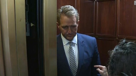 Sen. Jeff Flake, minutes after he announced he will support Supreme Court nominee Brett Kavanaugh, was confronted at the US …