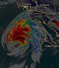 Hurricane Rosa was spinning toward the Baja Peninsula on Sunday as a Category 1 storm with sustained winds of 85 mph, the National Hurricane Center said.