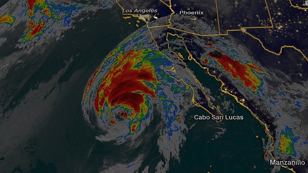 Hurricane Rosa was spinning toward the Baja Peninsula on Sunday as a Category 1 storm with sustained winds of 85 mph, the National Hurricane Center said.