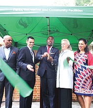 Mayor Levar M. Stoney, center, cuts the ribbon to reopen Monroe Park on Sept. 27. He is flanked by VCU President Michael Rao and Alice M. Massie, president of the park’s new governing body, the Monroe Park Conservancy, and other dignitaries. The nearly 8-acre space was Richmond’s first public park when the city acquired the land in 1851. The reopening will allow churches and other groups to resume serving meals to the homeless on weekends. The Monroe Park Conservancy has a 30-year lease with the city to operate and manage the park in cooperation with the city’s Department of Parks, Recreation and Community Facilities. (Regina H. Boone/Richmond Free Press)