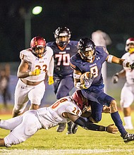 Virginia State University senior Josh Harris, a wide receiver from Hanover High School, slips past Shaw University’s Matthew Bush during last Saturday’s first home game at Rogers Stadium in Ettrick. 