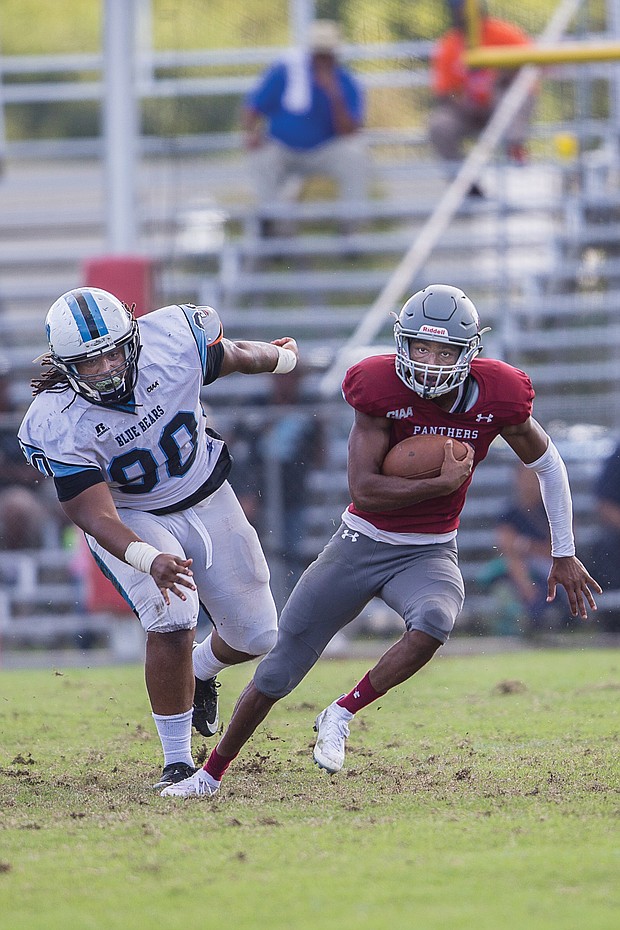 Panthers quarterback Darius Taylor streaks past Livingstone College’s William Moore Jr. during last Saturday’s game at Hovey Field. Virginia Union University won the game 52-19.