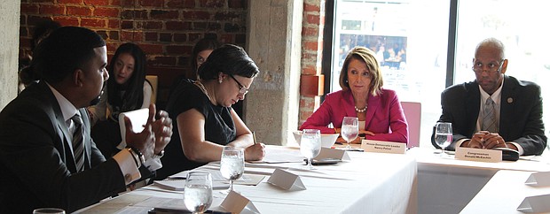 At left, Gilbert G. Campbell III, co-founder and managing partner of Volt Energy, makes a point during an infrastructure and environment roundtable discussion Oct. 5 in Richmond. Listening in are, from left, state Sen. Jennifer L. McClellan of Richmond, House Minority Leader Nancy Pelosi of California and 4th District Congressman A. Donald McEachin, the host of the event.