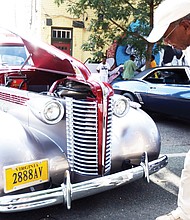 Robert Ford Sr. of Henrico County takes a closer look at a 1938 Buick 350 TP owned by Charles Muse of Richmond. The vintage auto was on display with others shown at the 2nd Street Festival by the Richmond Metropolitan Antique Car Club. (Regina H. Boone/Richmond Free Press)