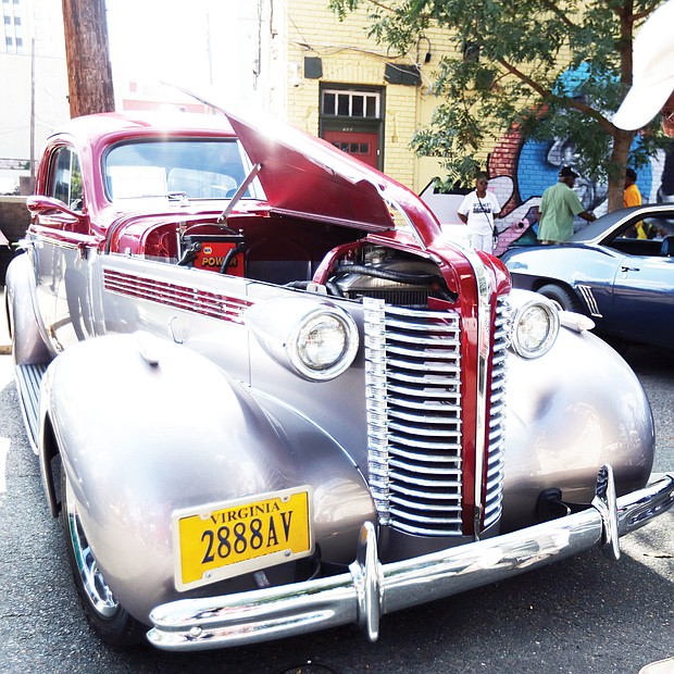 Robert Ford Sr. of Henrico County takes a closer look at a 1938 Buick 350 TP owned by Charles Muse of Richmond. The vintage auto was on display with others shown at the 2nd Street Festival by the Richmond Metropolitan Antique Car Club. (Regina H. Boone/Richmond Free Press)