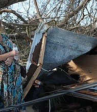 Kathy Coy stands among what is left of her home after Hurricane Michael destroyed it in Panama City, Florida. She said she was in the home when it was blown apart and is thankful to be alive.