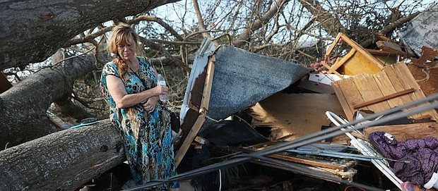 Kathy Coy stands among what is left of her home after Hurricane Michael destroyed it in Panama City, Florida. She said she was in the home when it was blown apart and is thankful to be alive.