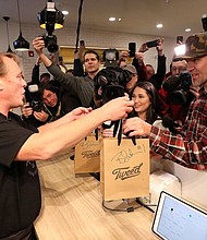 People in Canada are cheering, enduring long lines and honking their car horns in support as the country's first marijuana dispensaries open their doors Wednesday.