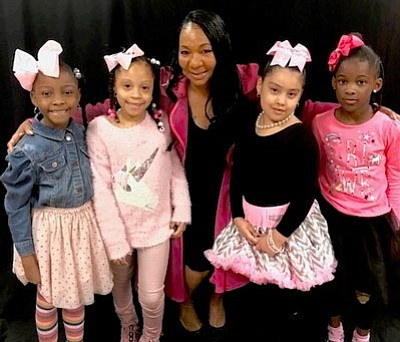 These children from God’s Little Angles Academy are the ambassadors for the event. They are posing with Kimberly Salley. founder of God’s Little Angels.