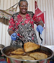 Frances Davis of Rocky Mount demonstrates the art of making fried apple pies during the Richmond Folk Festival. (Sandra Sellars/Richmond Free Press)