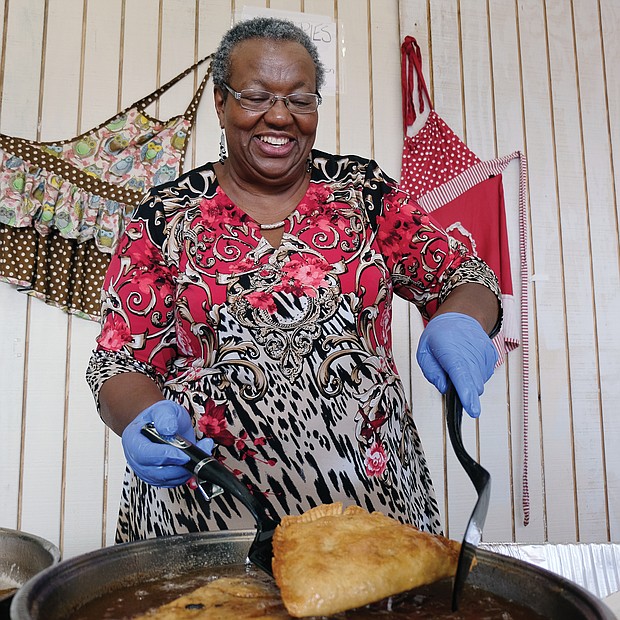 Frances Davis of Rocky Mount demonstrates the art of making fried apple pies during the Richmond Folk Festival. (Sandra Sellars/Richmond Free Press)