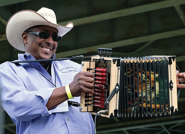 Leroy Thomas & the Zydeco Roadrunners of Elton, La., have spectators dancing with the unique accordion sound at the Richmond Folk Fest. (Sandra Sellars/Richmond Free Press)