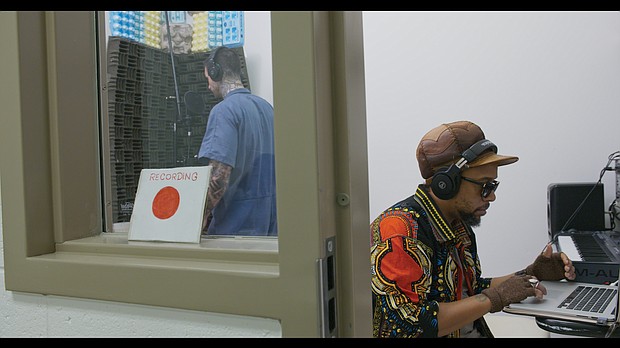 Arrested Development lead man Todd “Speech” Thomas, right, works with inmates in the Richmond City Justice Center’s small recording studio.