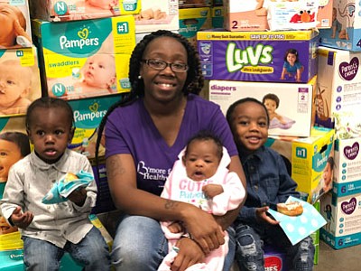 Sierra Mason with her baby Saniya, along with Za’Mari and Za’Vion Nipper. They were among those in attendance at a pamper drive distribution event held at the University of Maryland Baltimore County