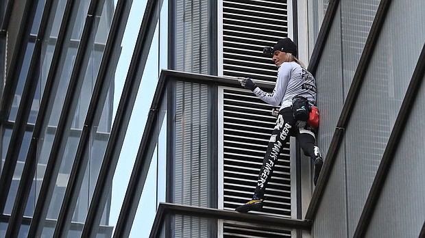 A daredevil climber known as the "French Spiderman" has scaled a London skyscraper with his bare hands.