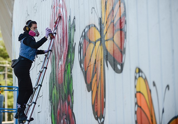 Artists Mee-Mee Caston and Sir James Thornhill begin painting a new mural on a concrete wall that faces Martin Luther King Jr. Middle School on Mosby Street in the East End. A volunteer team of about 10 students participated in designing the new tribute to Dr. King and also will take part in the painting, Mr. Thornhill said. (Photos by Clement Britt)