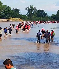 Migrants cross the Suchiate River into Mexico.