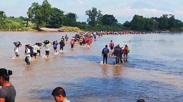 Migrants cross the Suchiate River into Mexico.