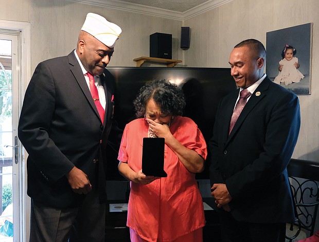 Towanda C. Lee of Mechanicsville cries as she and her brother, Damon R. Charity, right, receive the Congressional Gold Medal for their father, the late Sgt. Herman Russell Charity Sr., who was one of the nation’s Montford Point Marines. Retired Master Sgt. Forest E. Spencer Jr., left, presented the award.