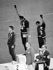 Athletes Smith, center, and Carlos give the Black Power Salute during the medal ceremony at the 1968 Summer Olympics in Mexico City. Smith finished first in the 200-meter sprint, while Peter Norman of Australia finished second and Carlos, third. All three wore human rights patches on their jackets.
