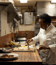 Dolester Miles brushes egg wash onto an apple crostata in the kitchen of Bottega. (Rob Culpepper/For The Washington Post)